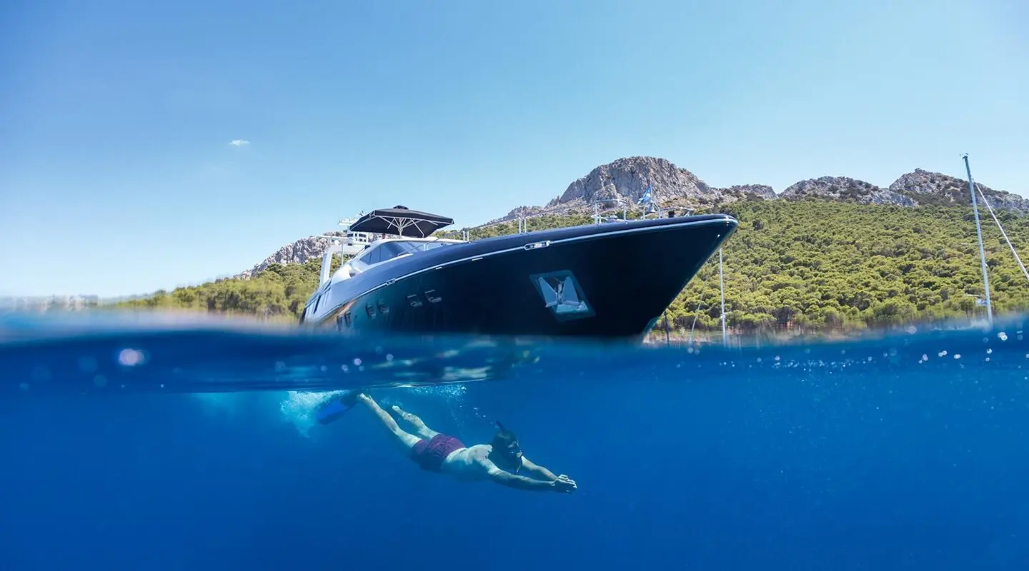 Aquarella luxury yacht anchored at sunset with calm blue water and hills