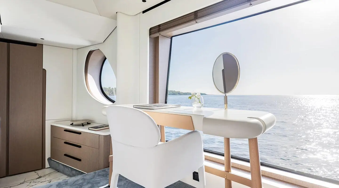 Viva II yacht interior desk by large window overlooking sea
