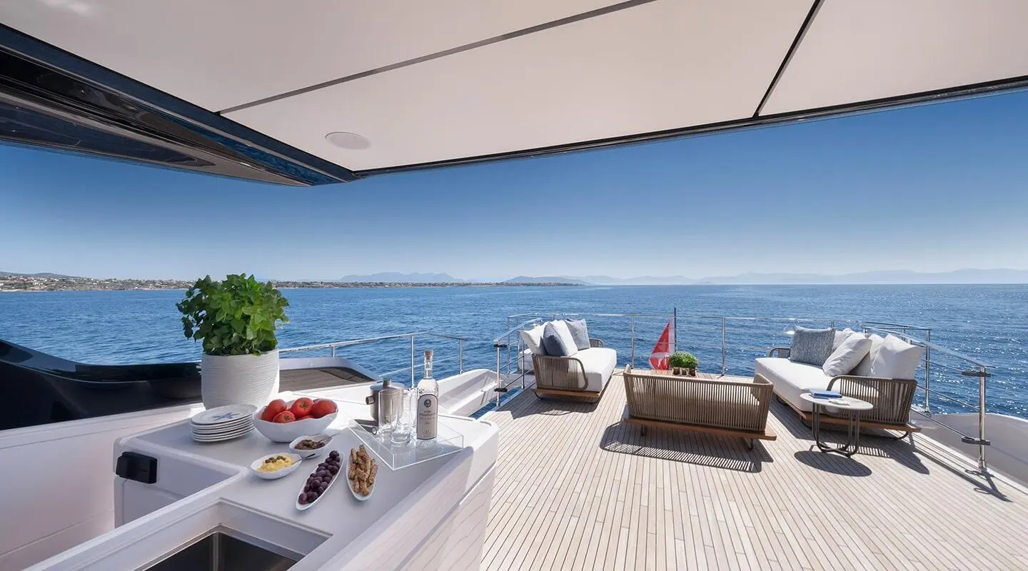 Spica yacht deck with white loungers facing bright sea and blue horizon