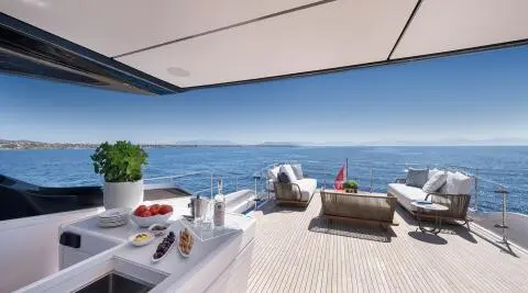 Spica yacht deck with white loungers facing bright sea and blue horizon