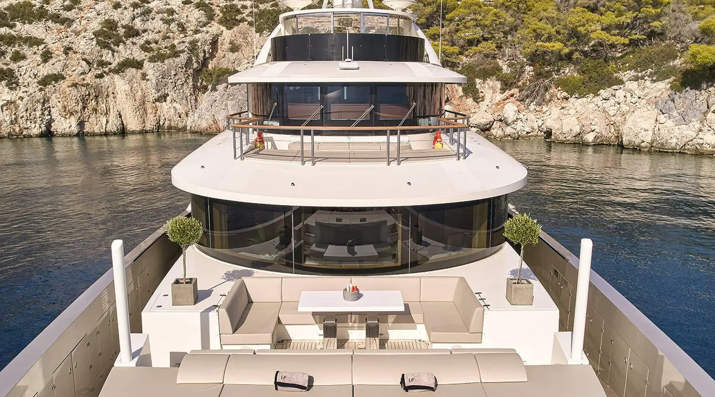 Front view of a luxury motor yacht with white seating on an open deck