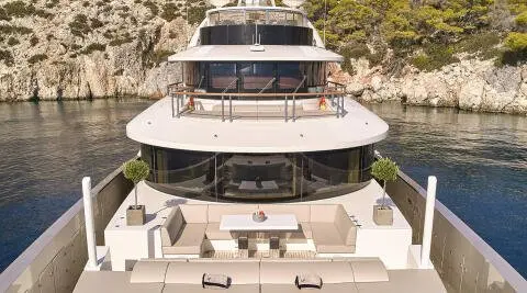 Front view of a luxury motor yacht with white seating on an open deck
