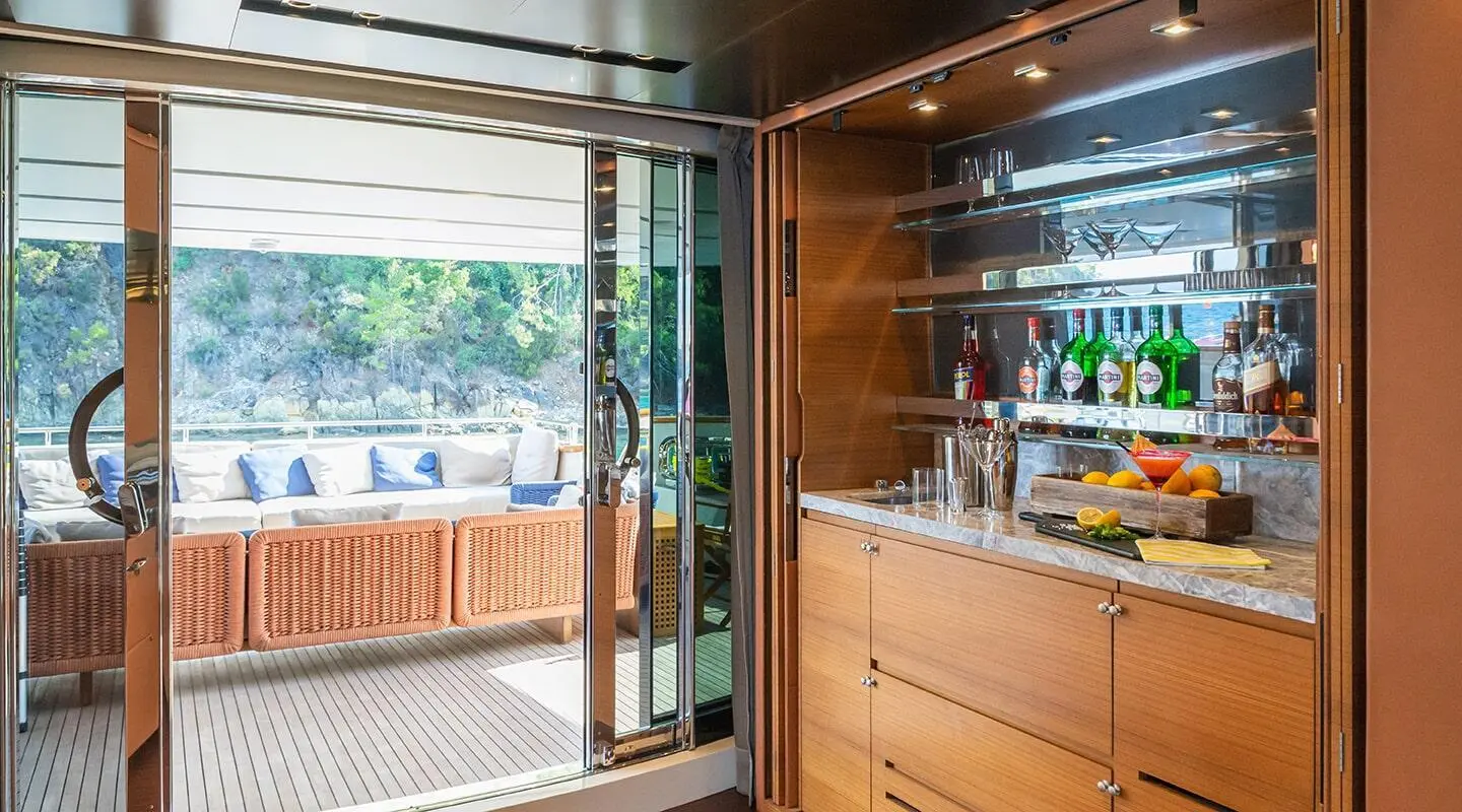 Takara One motor yacht saloon with wood paneling and large windows