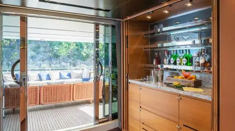 Takara One motor yacht saloon with wood paneling and large windows