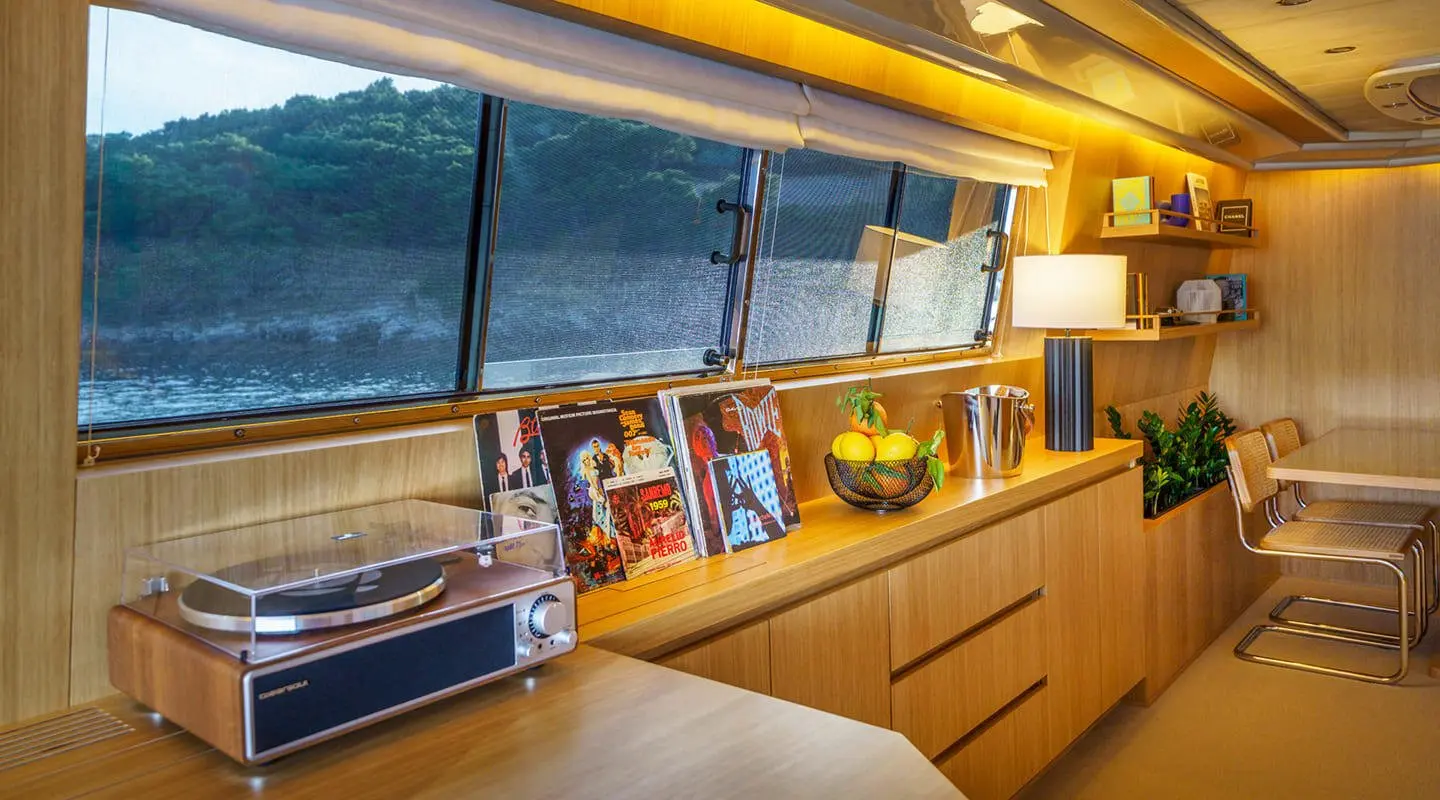 Phantom yacht saloon interior with wood cabinetry, seating, and framed photos
