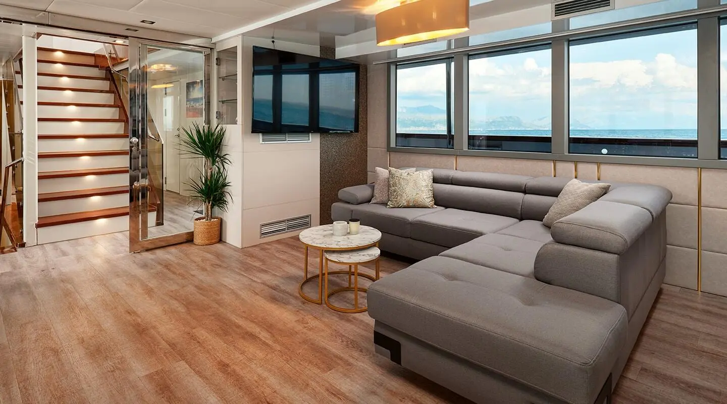Ohana luxury motor yacht interior: lounge with sofa, coffee table, windows