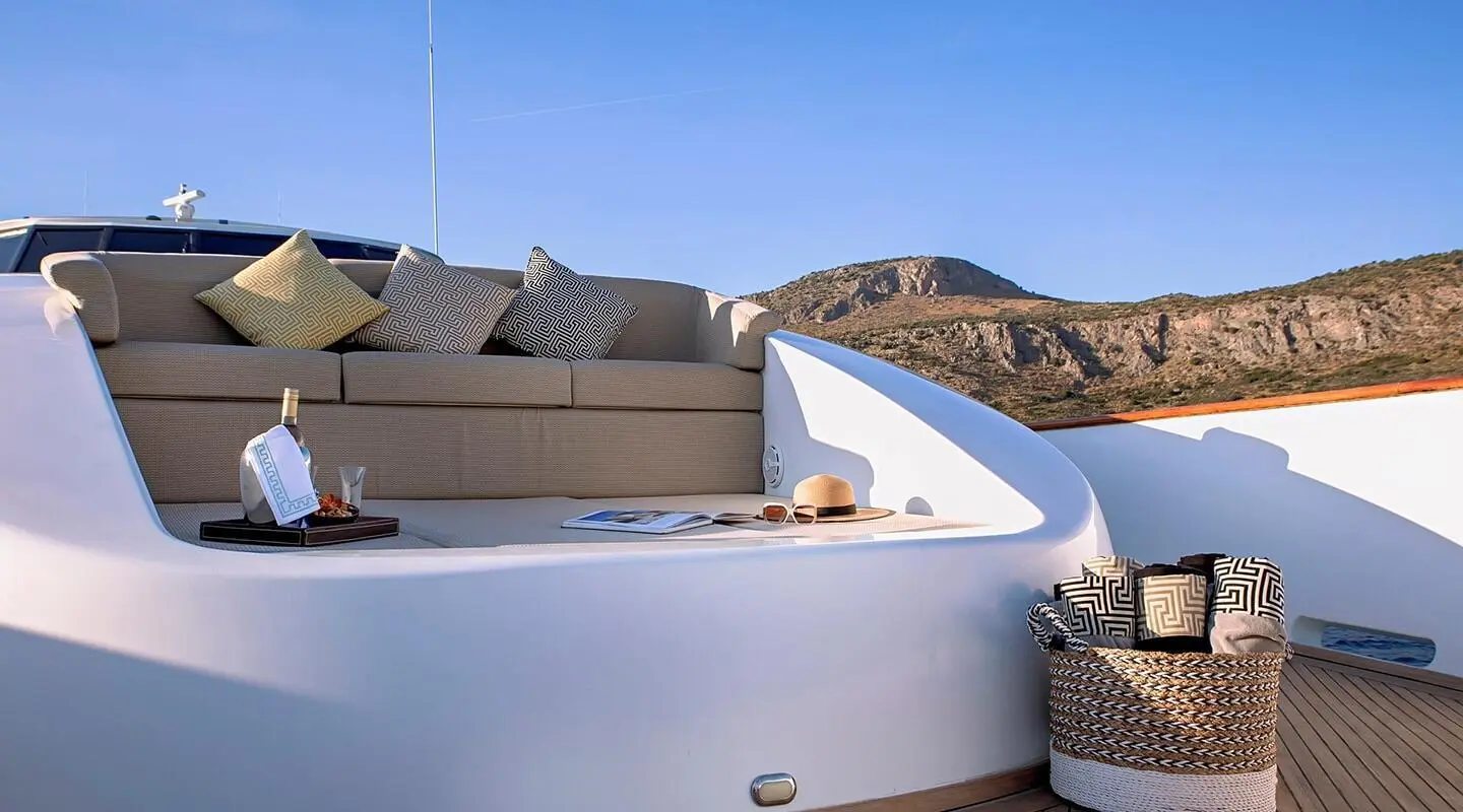 Aquila luxury yacht deck scene with white railings and sunlit seating
