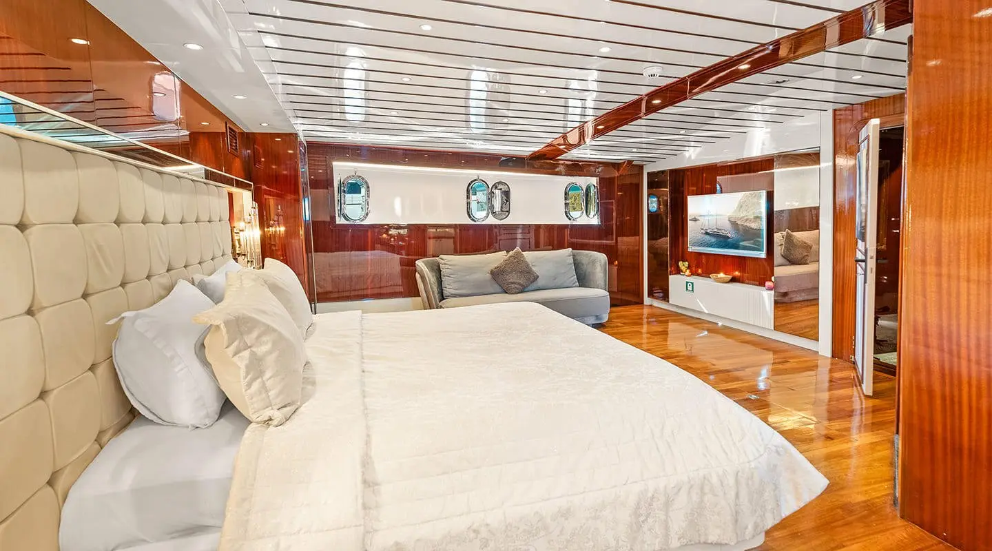 Interior of Esma Sultan gulet master cabin with large bed and porthole windows