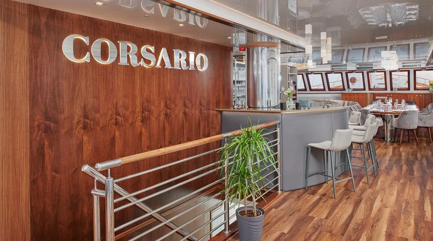 Gulet Corsario yacht deck with wooden railings and stairs to saloon