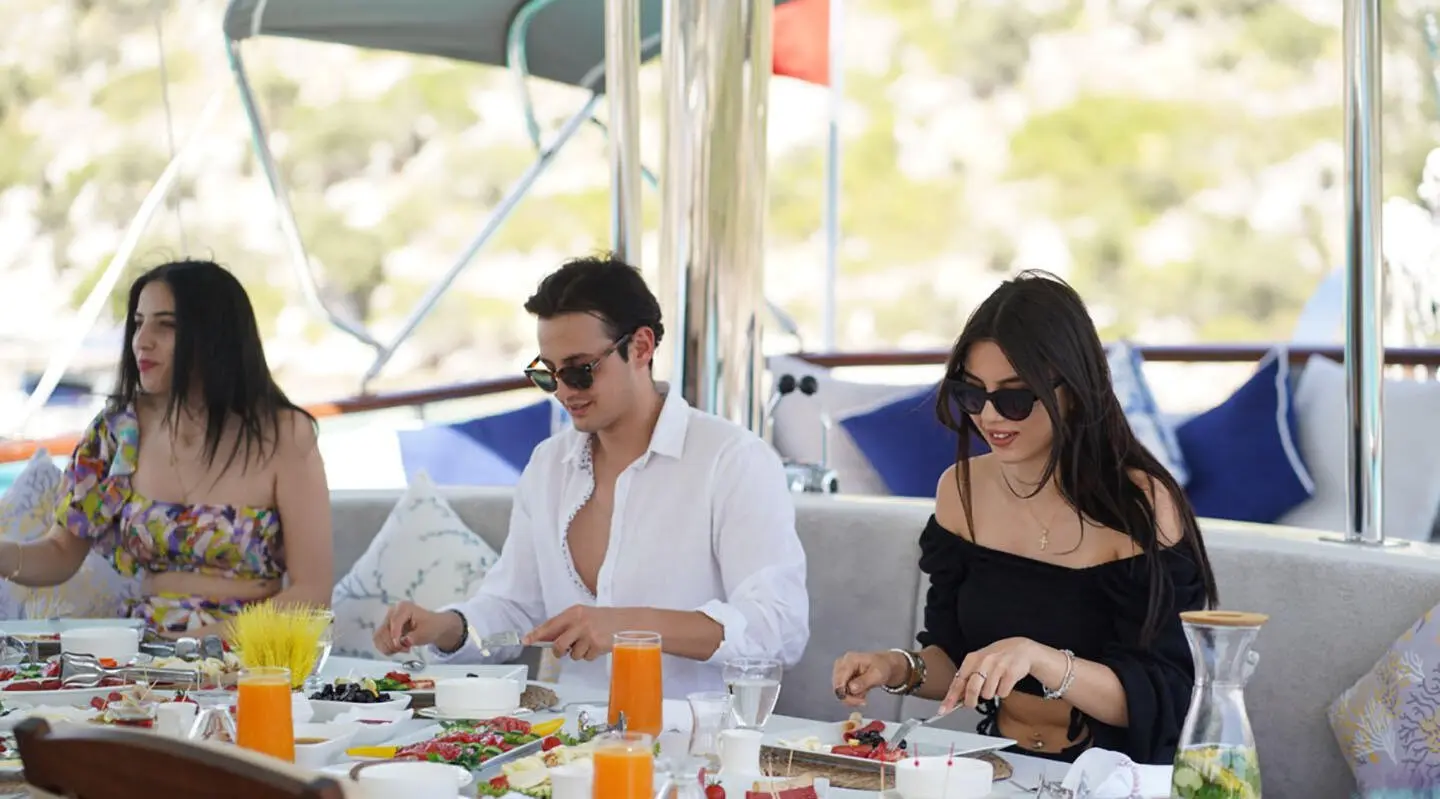 Three people dining on a yacht deck during breakfast on Prenses Esila gulet