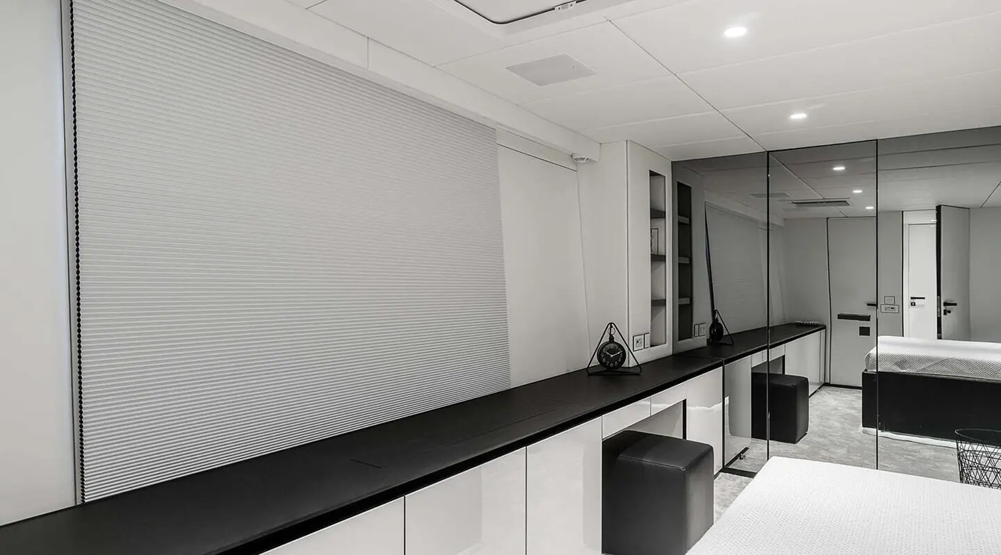 Luxurious yacht interior with white walls, ceiling lights, and a sleek black counter