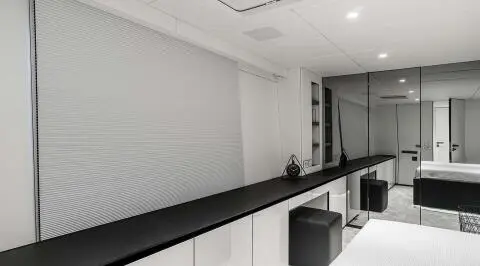 Luxurious yacht interior with white walls, ceiling lights, and a sleek black counter
