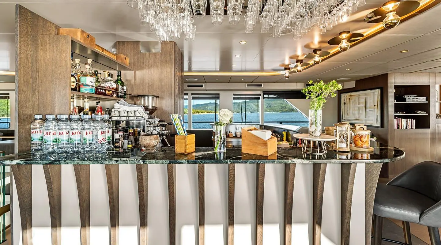 Interior view of Anima Maris saloon featuring seating, bar, and decorative lighting