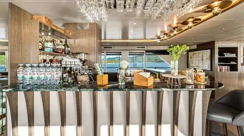 Interior view of Anima Maris saloon featuring seating, bar, and decorative lighting