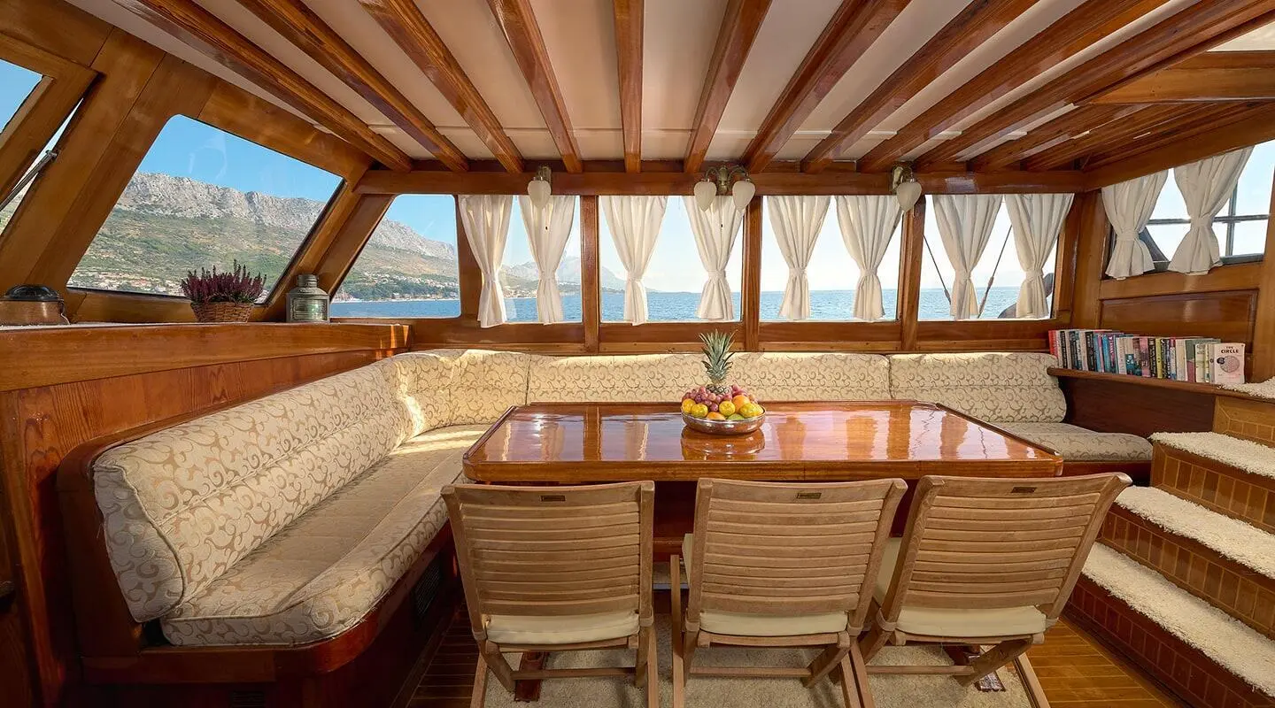 Linda luxury gulet interior with wooden deck seating and windows