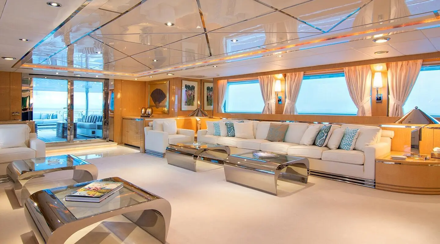 O'Natalina yacht salon interior with seating, wood accents, and large windows