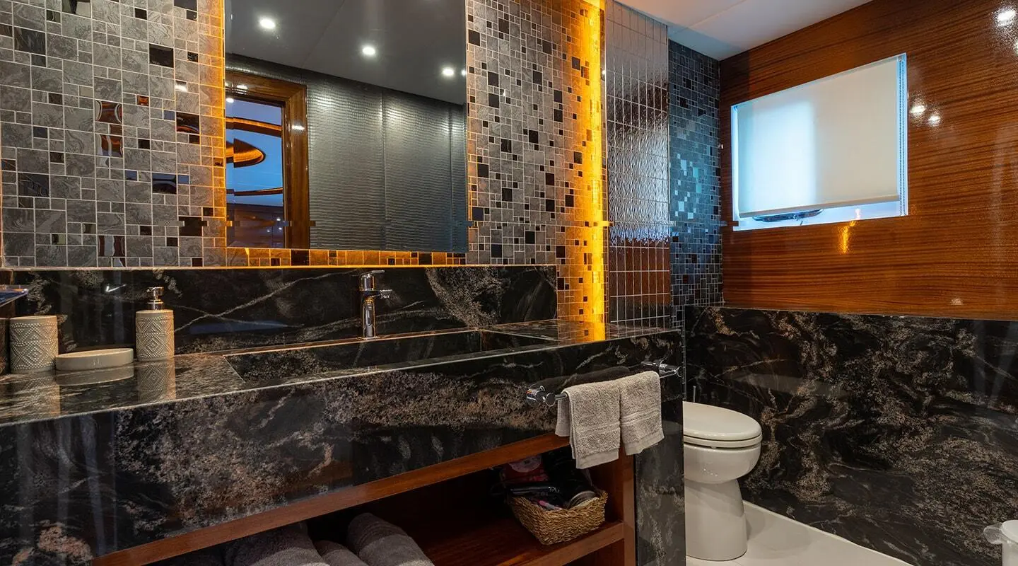 Yacht Long Island interior with dark marble walls, warm lighting, and seating area