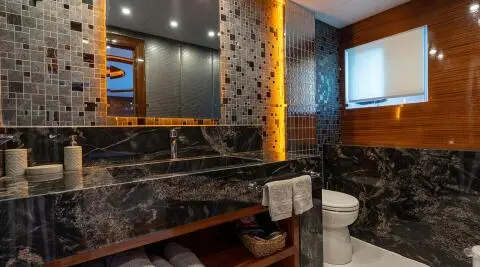 Yacht Long Island interior with dark marble walls, warm lighting, and seating area