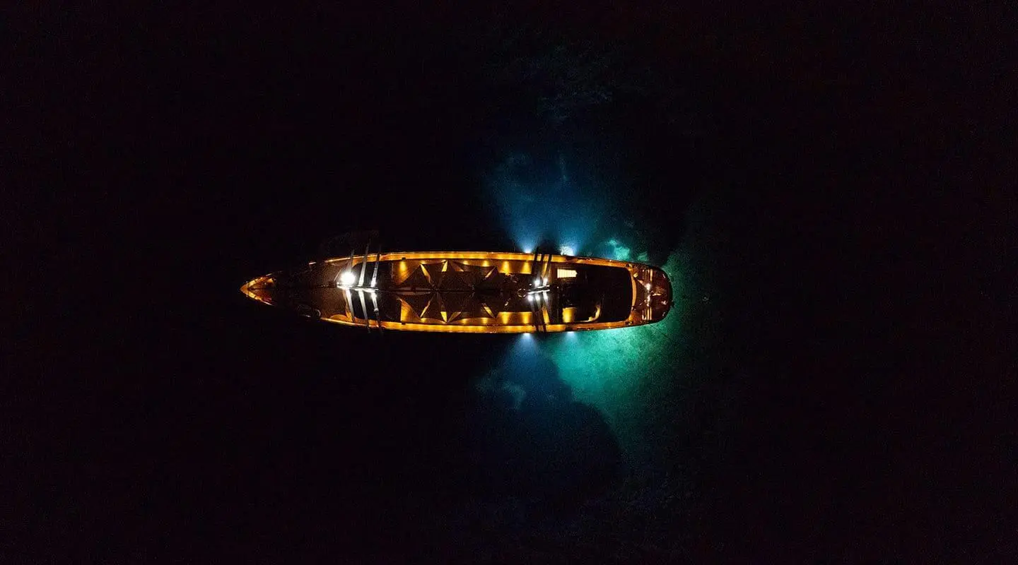 Dalmatino luxury yacht glowing at dusk, anchored in calm turquoise waters