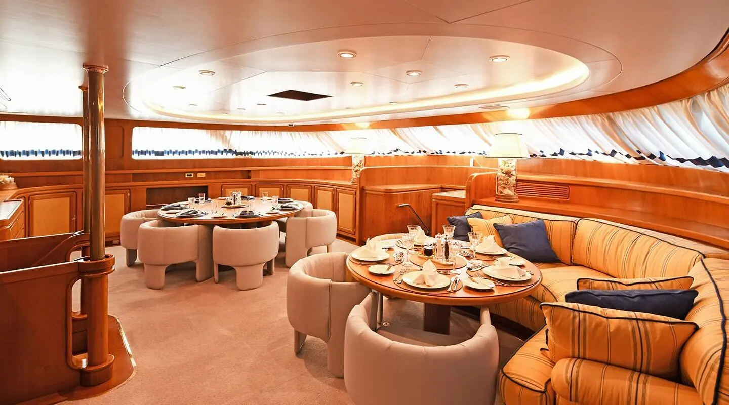 Tamarita luxury yacht dining saloon with round booths and tables