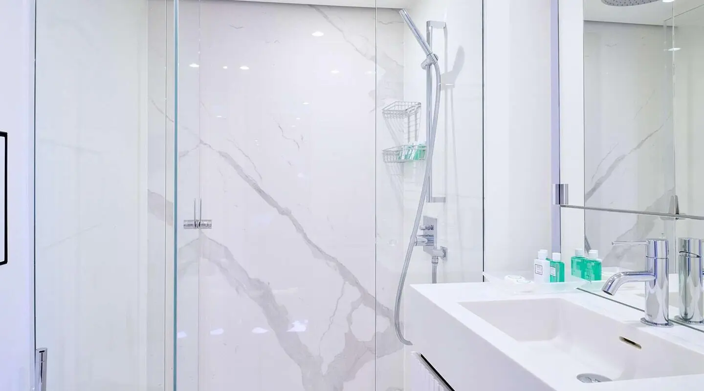 Genny luxury yacht bathroom interior with marble walls and glass shower enclosure