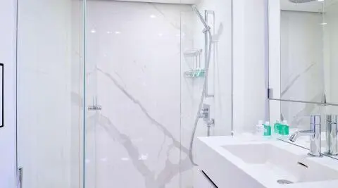 Genny luxury yacht bathroom interior with marble walls and glass shower enclosure