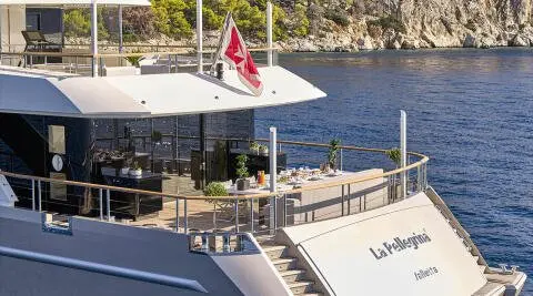 La Pellegrina 1 yacht docked at sunset with dining area on deck and water
