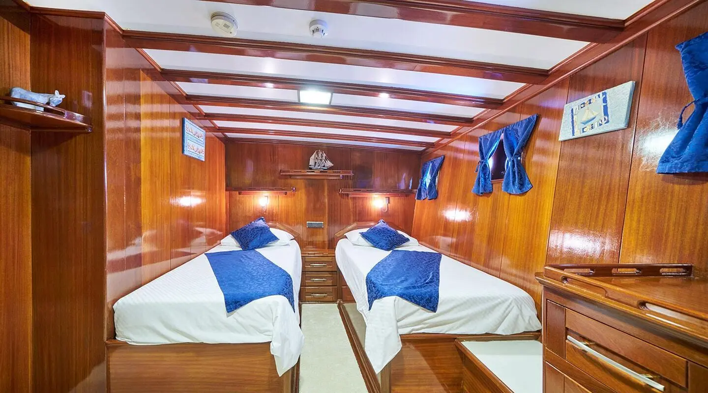 Interior of Stella Maris yacht gulet with twin bunks and wooden ceiling