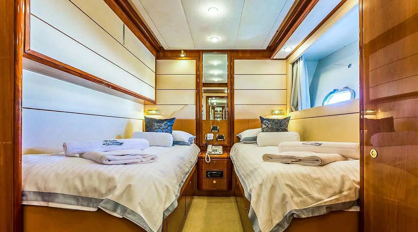 Luxurious yacht Miss Katariina cabin with two beds and wood paneling
