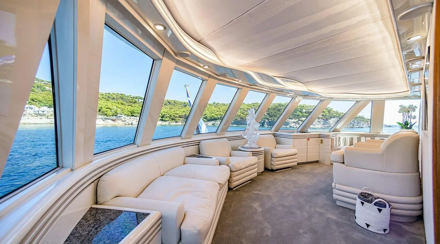 Wind Of Fortune yacht interior with light lounge seating and large windows