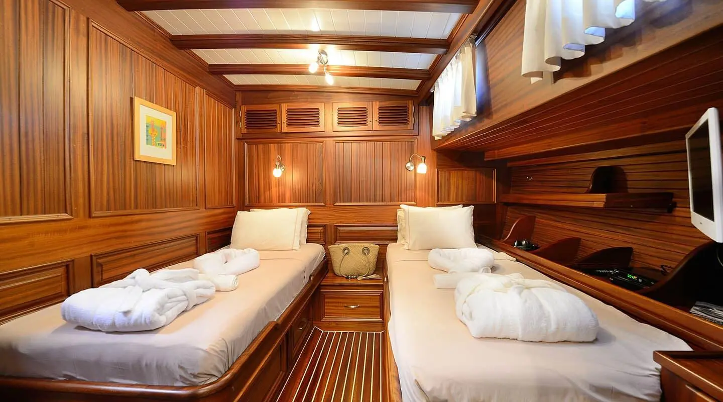Interior of Zephyria II gulet with twin cabin berths and wooden paneling