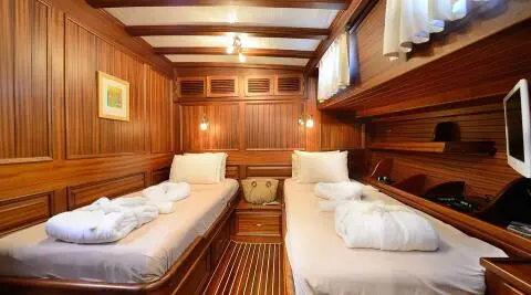Interior of Zephyria II gulet with twin cabin berths and wooden paneling