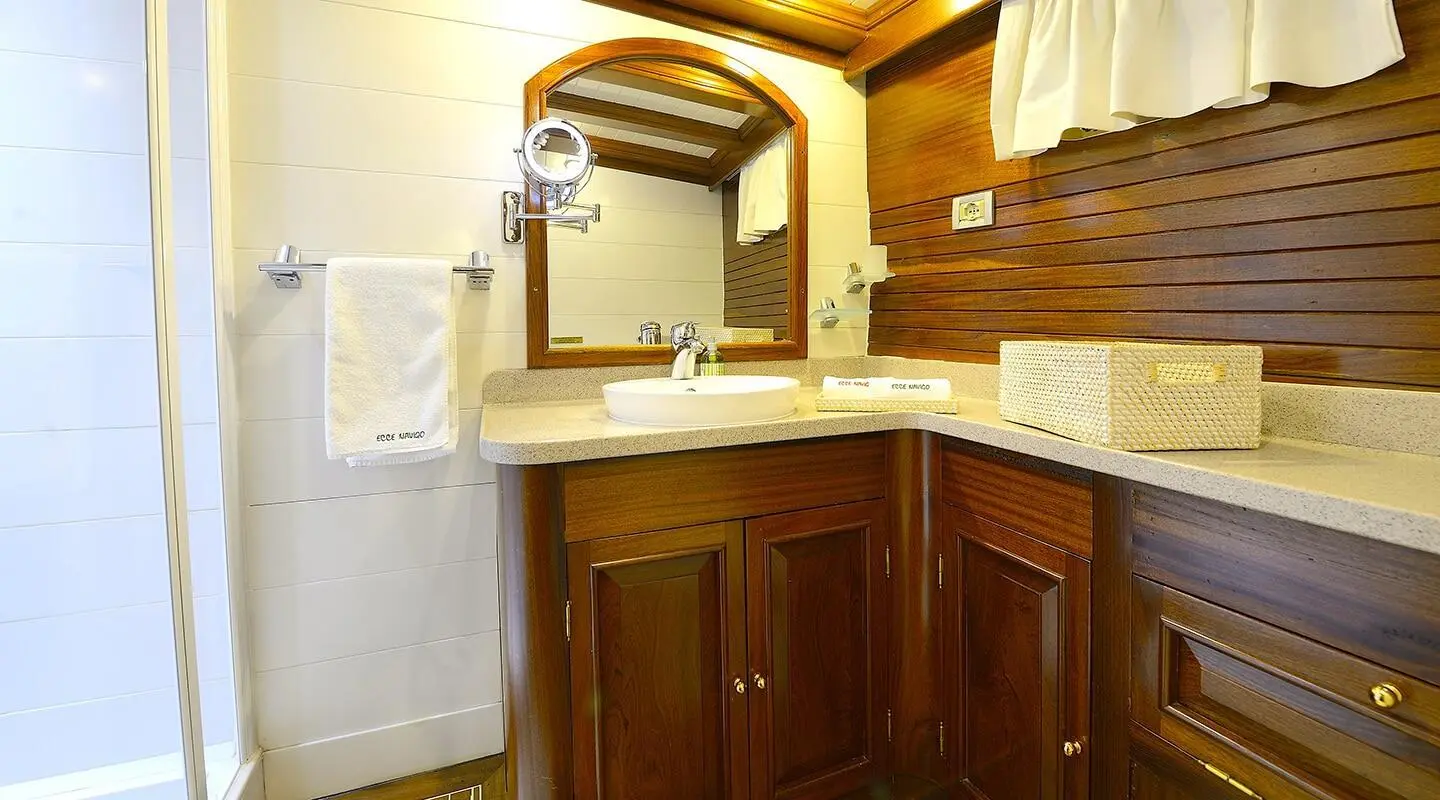 Ecce Navigo luxury gulet at sea sunset with deck and sails in view