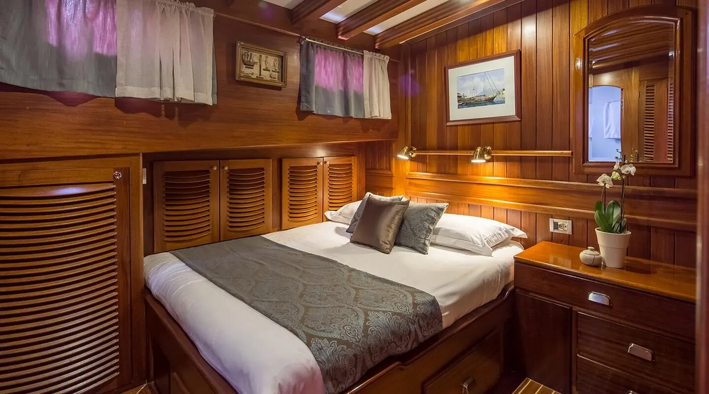 Interior shot of Carpe Diem 7 yacht cabin with wooden walls and bed