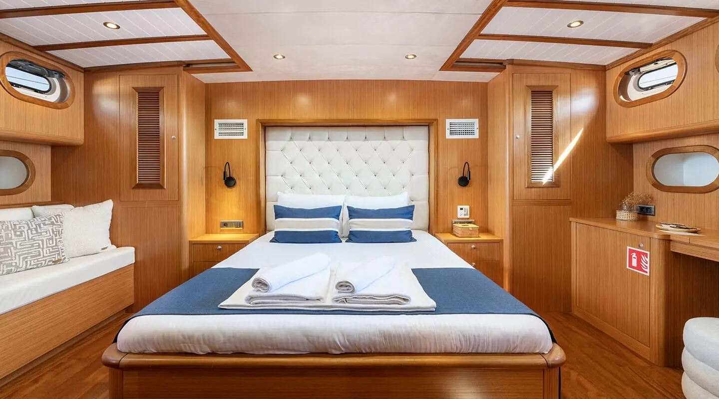Gozdem The One master cabin aboard a yacht with two single beds and wooden panels