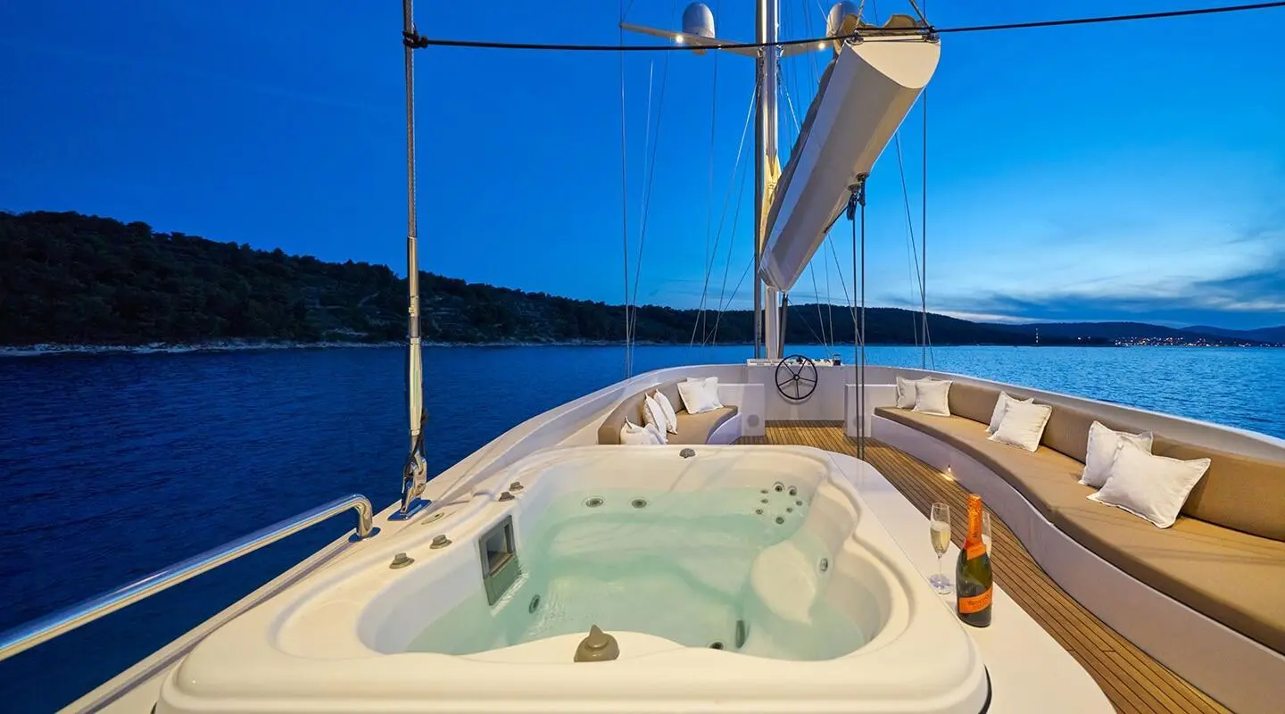 Yacht Acapella bow jacuzzi on forward deck with rigging and blue water