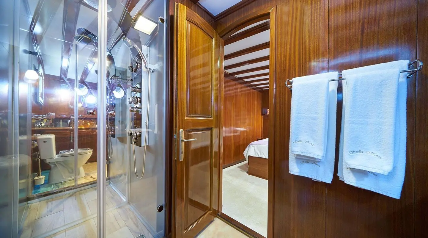 Stella Maris luxury gulet at sunset with polished wooden cabin interior and stairs