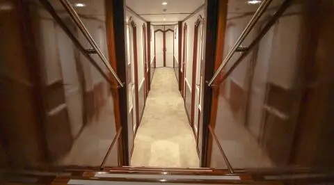 A luxurious yacht interior corridor on Aurum with polished wood panels