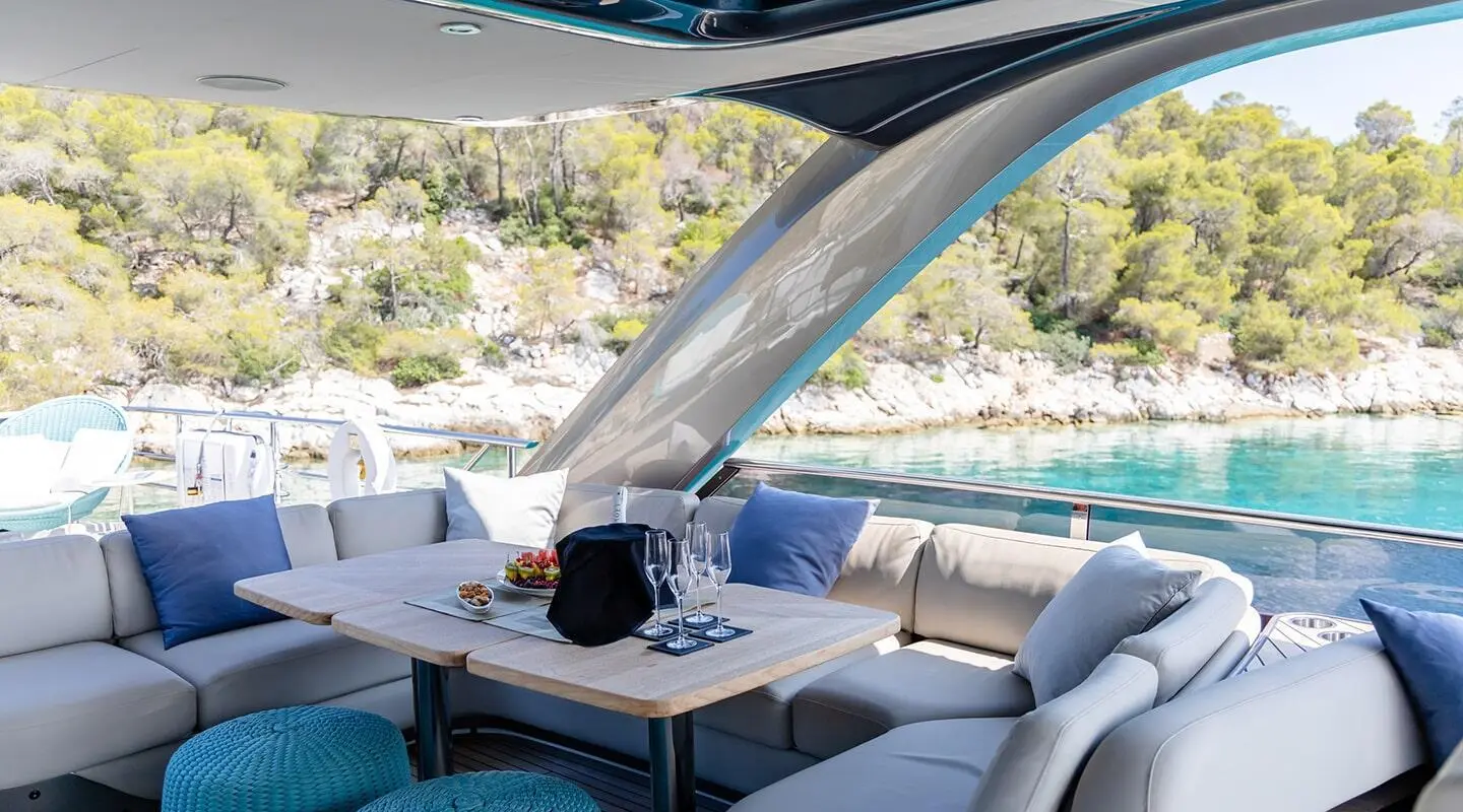 Vista yacht sundeck dining area with seating, table, and shade sails
