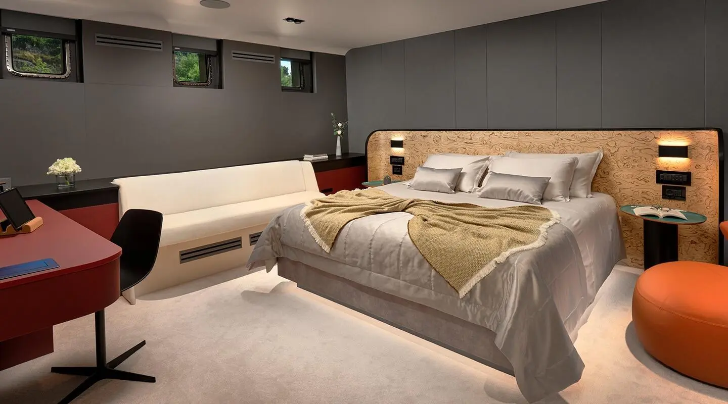 Luxury yacht Anetta bedroom with large bed, neutral tones, and soft lighting