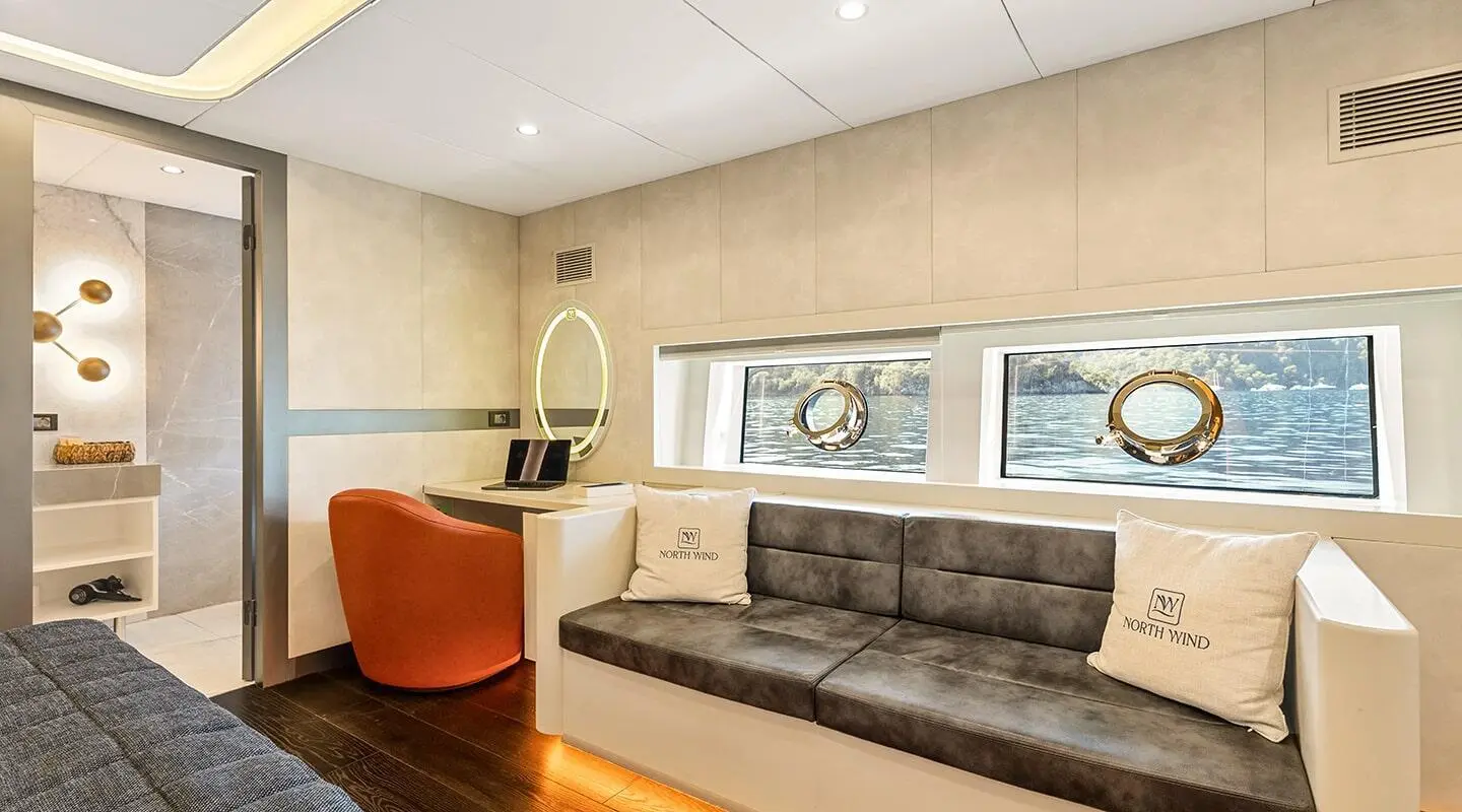 Interior lounge on North Wind yacht with couch, chairs, and windows