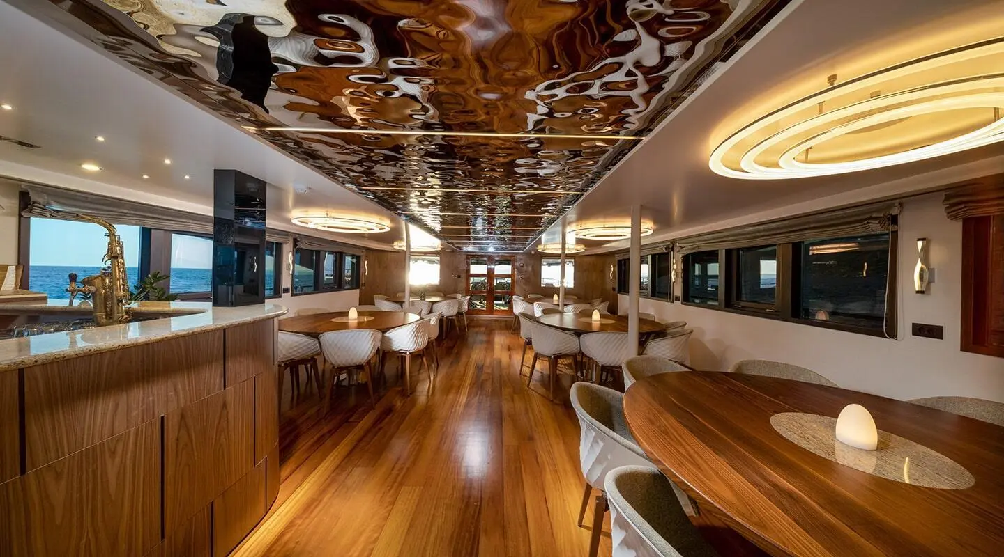 Interior of Olimp luxury yacht saloon with polished wood floors and seating