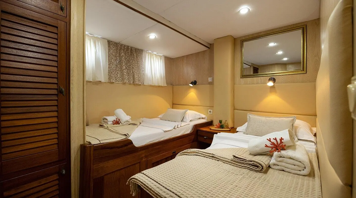 Interior of Aborda luxury gulet yacht with twin beds and warm lighting