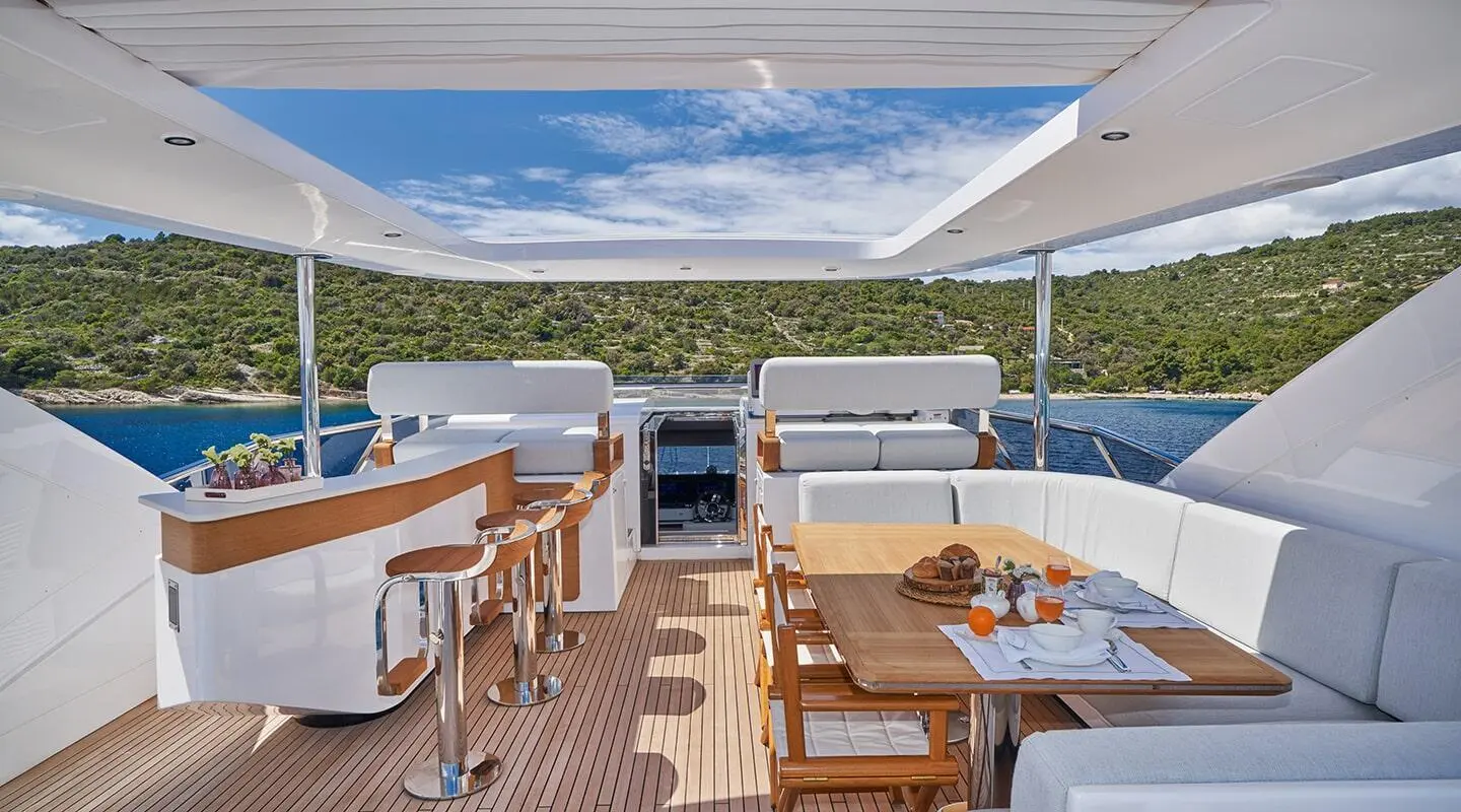 Outdoor yacht lounge on Aluminia Too with seating, table, and ocean view