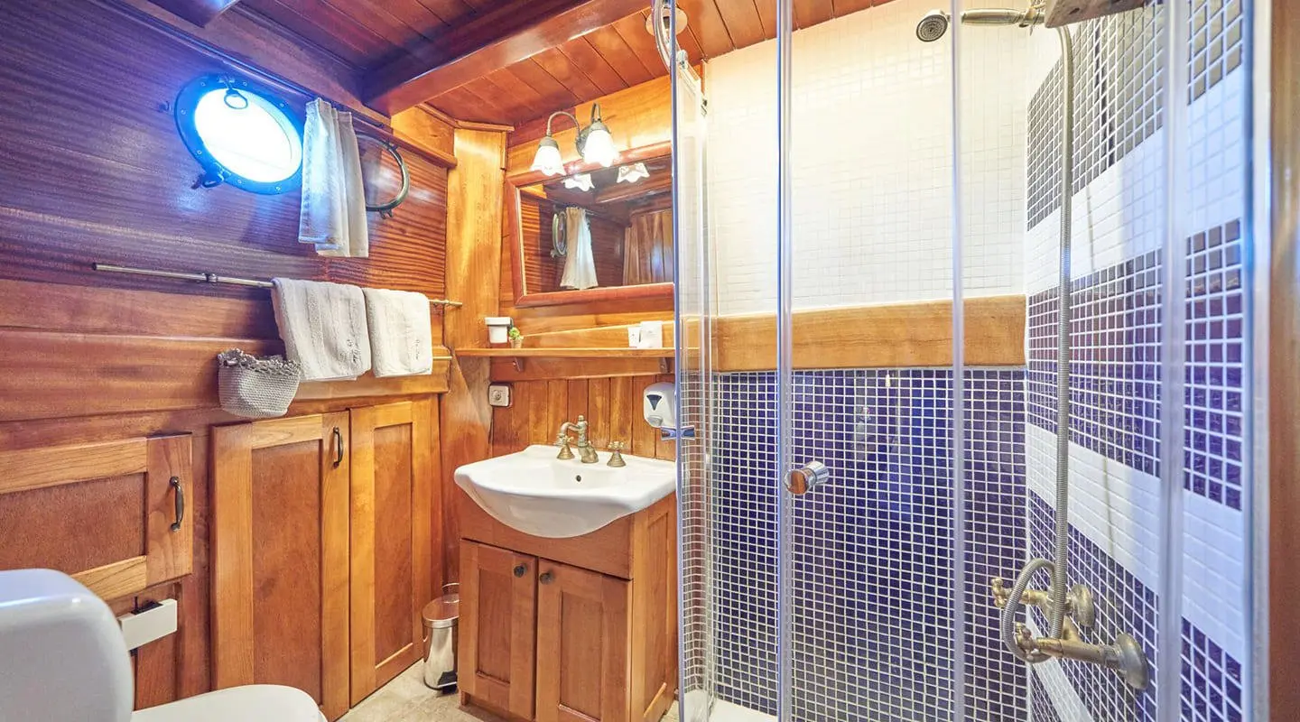 Libra gulet master cabin en-suite with wooden cabinets and sink