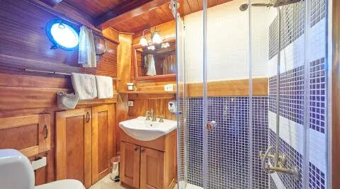 Libra gulet master cabin en-suite with wooden cabinets and sink