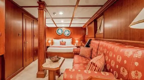 Interior of Seagull II yacht living area with cushions and wooden panels