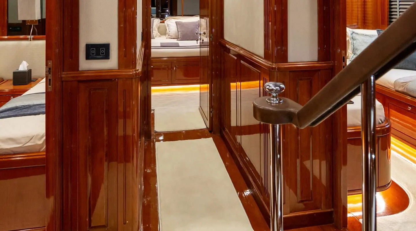 Interior hallway on a yacht with polished wood and cream carpeting