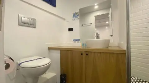 Maske 5 yacht interior bath area with sink, mirror and cabinetry at sunset