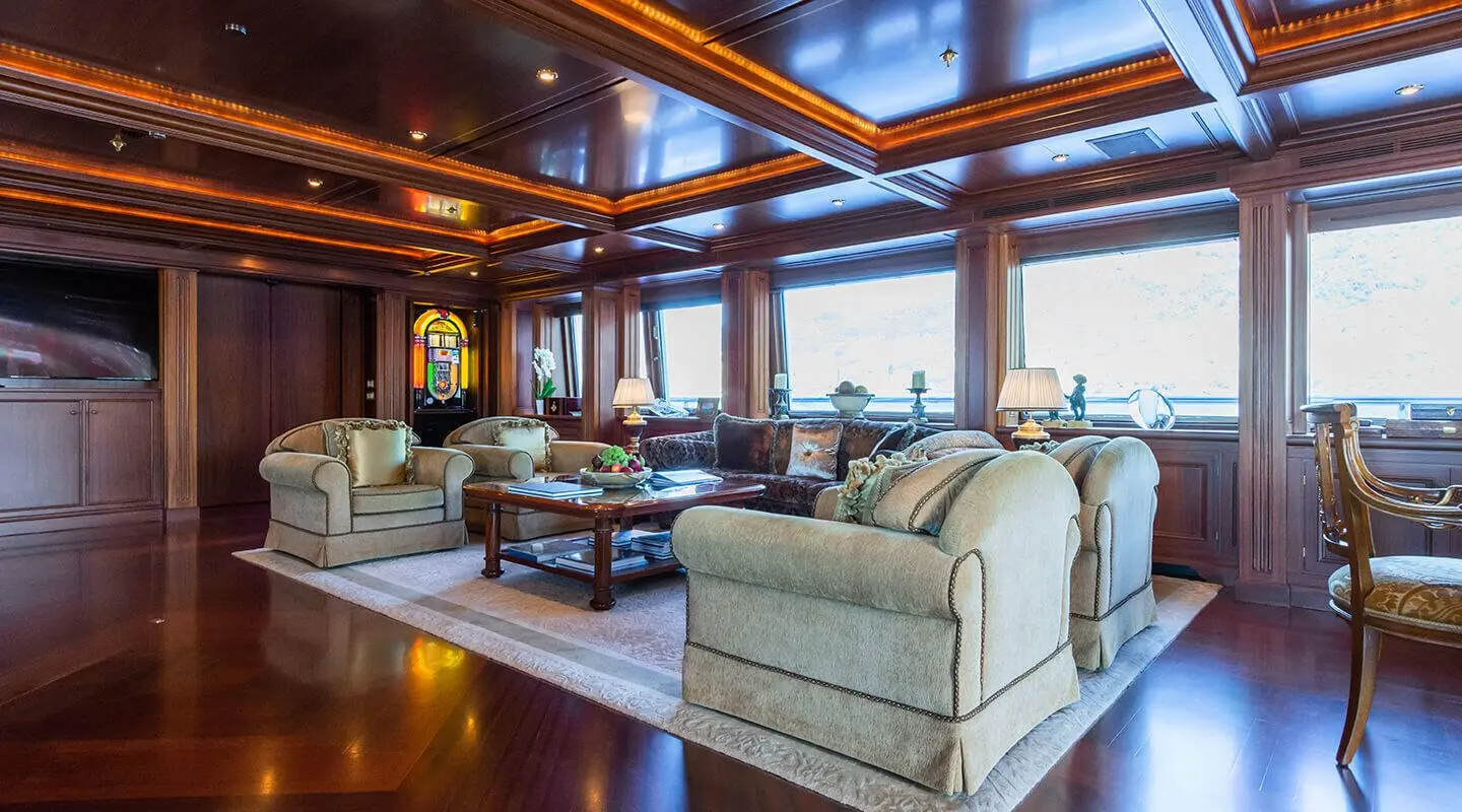 Luxurious yacht Apogee interior with white leather sofas and wooden panels